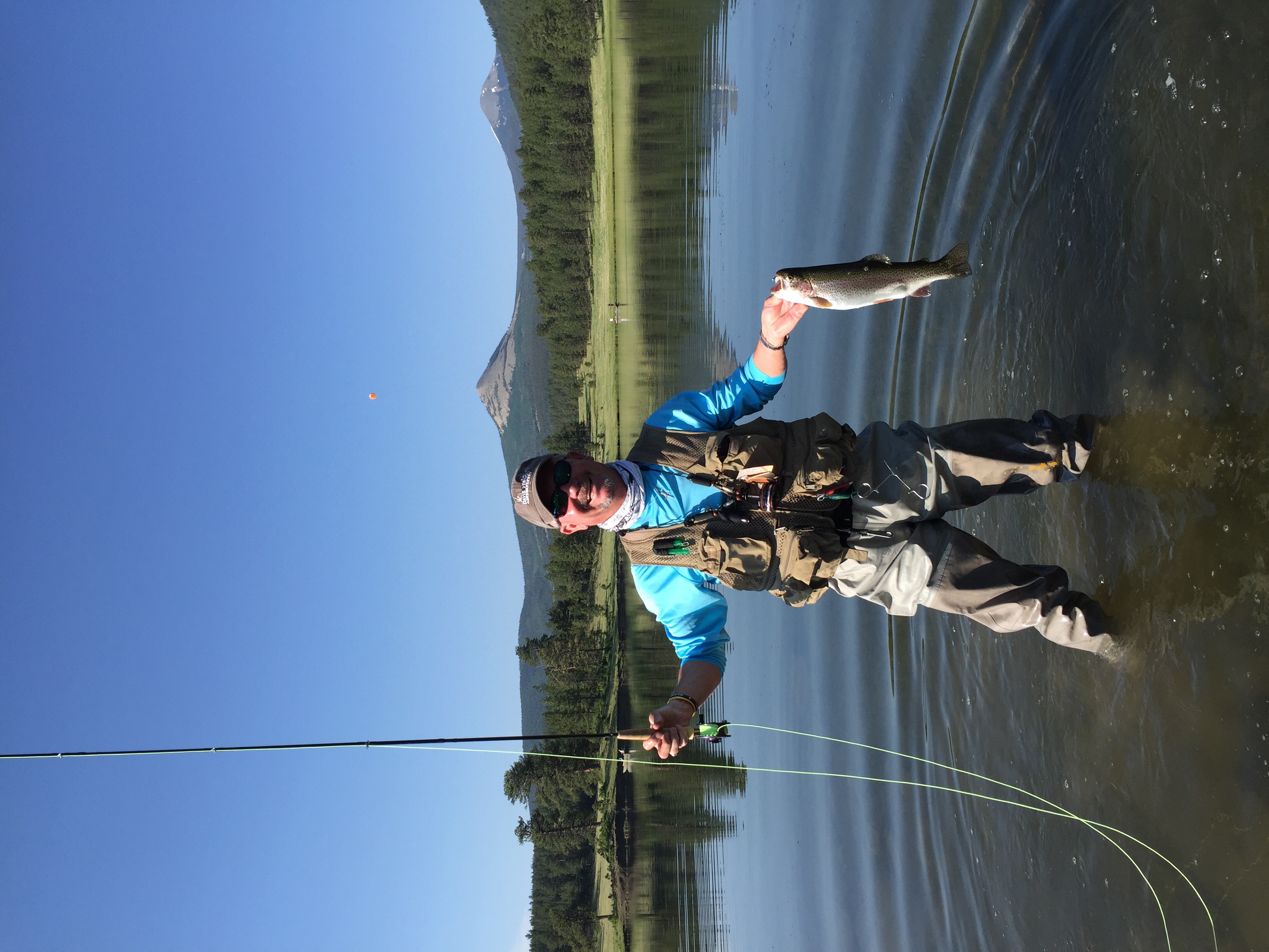 a guy fishing in a stream