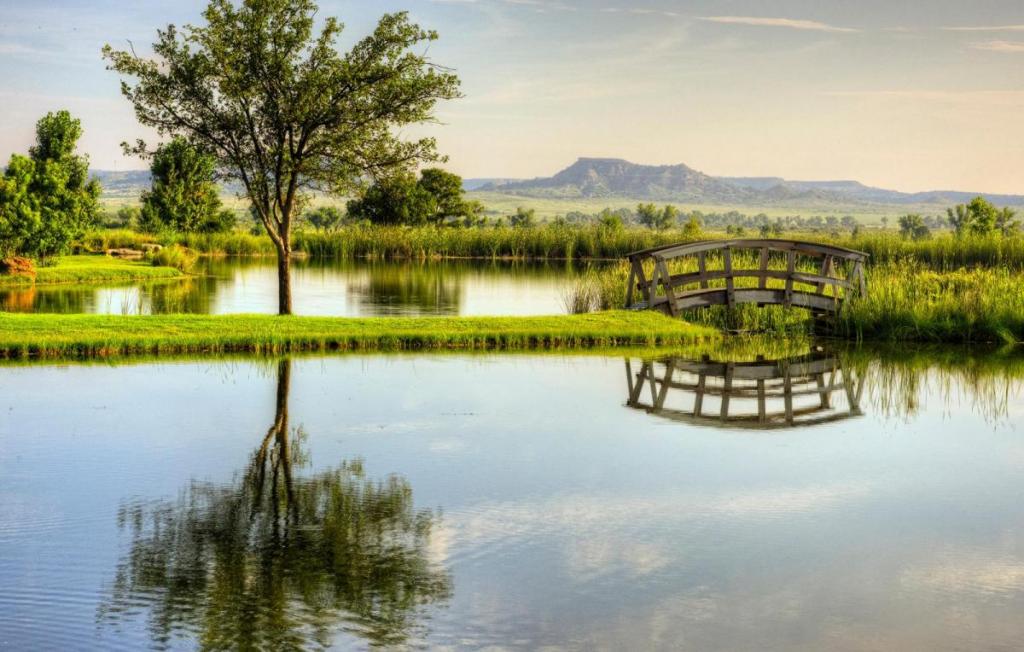 Mesa Vista Ranch pond, footbridge and scenic landscape